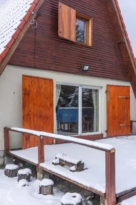 a house with snow on the ground in front of it at Villa Teodora in Kopaonik