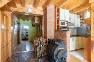 a kitchen with a brick fireplace in a house at Villa Teodora in Kopaonik