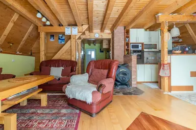 a living room with leather chairs and a table and a stove at Villa Teodora in Kopaonik