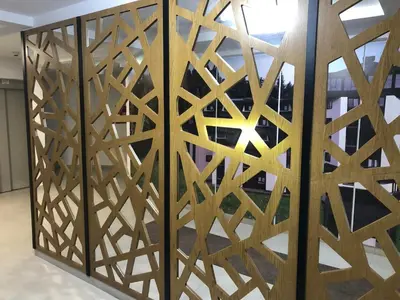 a wooden partition with a geometric design in a room at Apartmani A in Kopaonik