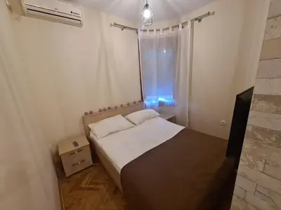 a small bedroom with a bed and a window at Happy Moments in Vrnjačka Banja