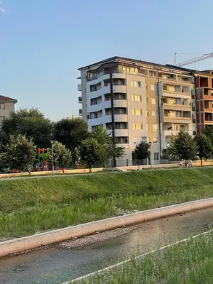 a large apartment building in front of a river at DREAM house in Paraćin