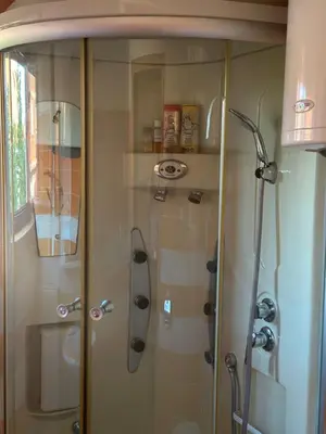 a shower with a glass door in a bathroom at Lilyy in Leskovac