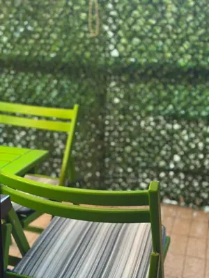 two green chairs sitting in front of a wall at Lilyy in Leskovac