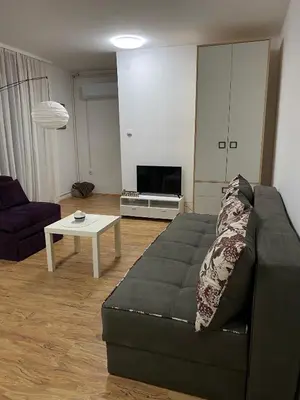 a living room with a couch and a table at Lilyy in Leskovac