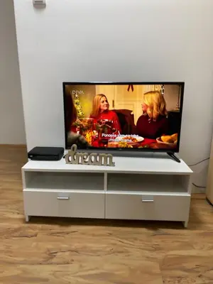 a flat screen tv sitting on top of a dresser at Lilyy in Leskovac
