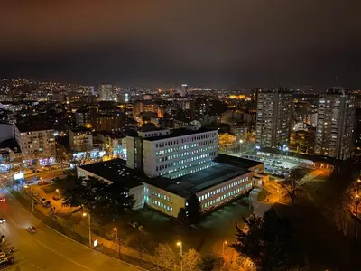 a view of a city at night with lights at Apartman Bonaca in Niš