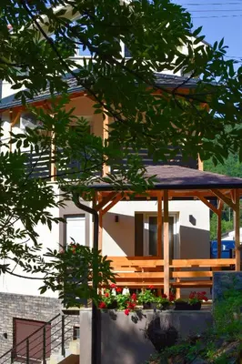 a house with a wooden gazebo at STIV Apartmani in Lukovo
