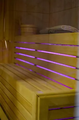 a wooden bench in a room with purple lights at STIV Apartmani in Lukovo