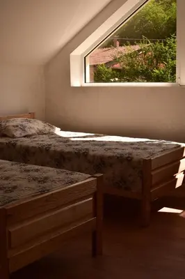 a bedroom with two beds and a window at STIV Apartmani in Lukovo