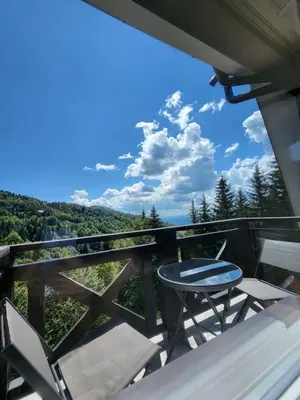 a patio with a table and chairs on a balcony at Apartman Mela Kop 11 in Kopaonik