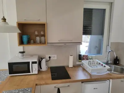 a kitchen counter with a microwave and a sink at Apartman Mela Kop 11 in Kopaonik
