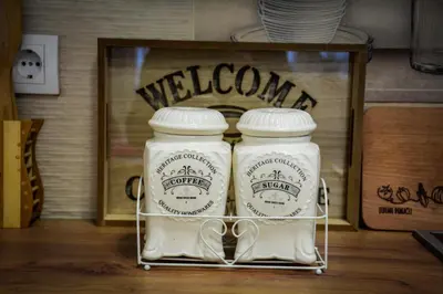 two mason jars sitting on a rack in front of a sign at Apartman Pašajlić in Vrnjačka Banja