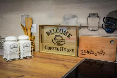 a counter with a welcome coffee house sign on it at Apartman Pašajlić in Vrnjačka Banja