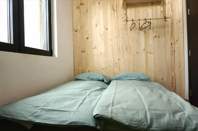 a bed in a room with a wooden wall at Montana in Kopaonik