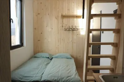 a small room with a bunk bed and a ladder at Montana in Kopaonik