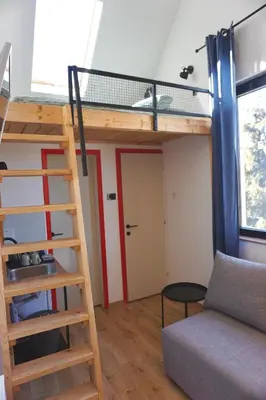 a room with a loft bed and a couch at Montana in Kopaonik