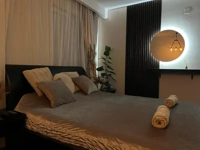 a bedroom with a bed with pillows on it at STUDIO DJORDJO in Kruševac