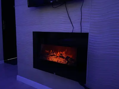 a fireplace in a room with a fire in it at STUDIO DJORDJO in Kruševac