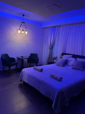 a bedroom with a large bed with blue lighting at STUDIO DJORDJO in Kruševac