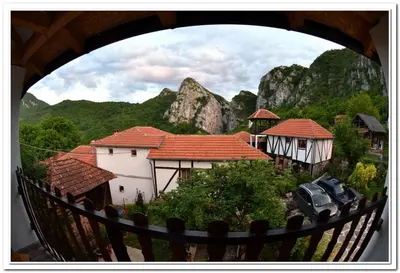 a view of a group of houses with mountains in the background at Golemi kamik Pirot Vlasi in Pirot