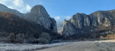 a road in front of a mountain range at Golemi kamik Pirot Vlasi in Pirot