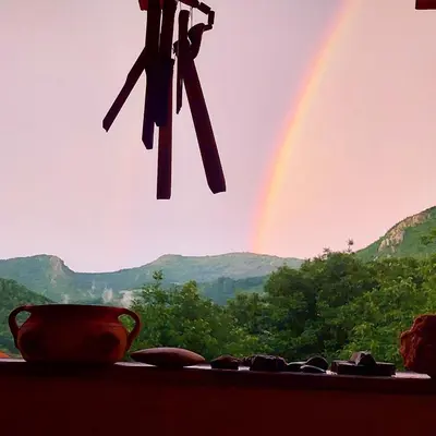 a rainbow in the sky with a pot and a pair of scissors at Golemi kamik Pirot Vlasi in Pirot