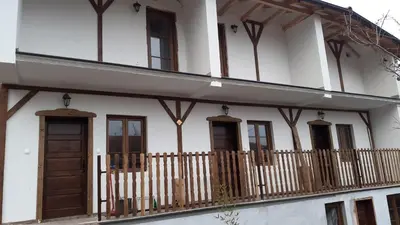 a white house with a fence and windows at Golemi kamik Pirot Vlasi in Pirot