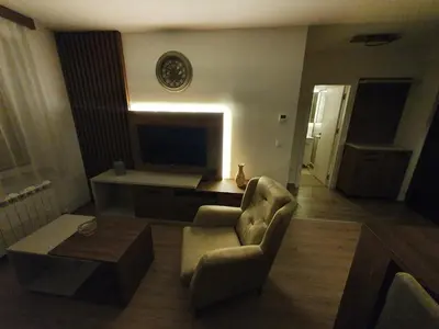 a living room with a chair and a television at Iznad oblaka A6 in Kopaonik