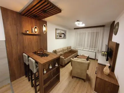 a living room with a couch and a table at Iznad oblaka A6 in Kopaonik