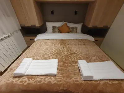a large bed with two white towels on it at Iznad oblaka A6 in Kopaonik