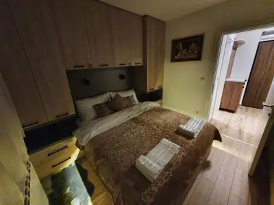 a small bedroom with a bed in a room at Iznad oblaka A6 in Kopaonik