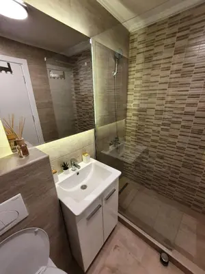 a bathroom with a sink and a shower at Iznad oblaka A6 in Kopaonik