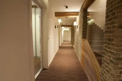 a hallway of a building with a brick wall at Apartman Zupa 112 in Kopaonik