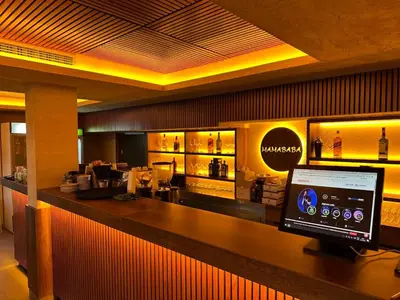 a bar in a restaurant with a computer on a counter at Milmari Resort N56 Kopaonik wellnes&spa in Kopaonik