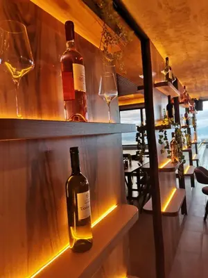 a bottle of wine on a shelf in a bar at Milmari Resort N56 Kopaonik wellnes&spa in Kopaonik