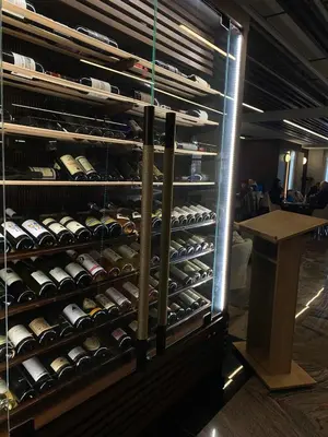 a wine rack with lots of bottles of wine at Pegaz114 in Vrnjačka Banja