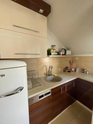 a kitchen with a white refrigerator and a sink at Charme apartman in Kruševac
