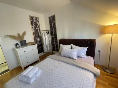 a bedroom with a bed with two towels on it at Charme apartman in Kruševac