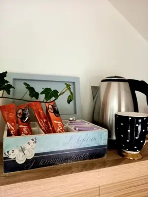 a box on a table with a pot and a vase at Charme apartman in Kruševac