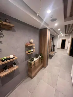 a hallway with potted plants on shelves in a building at PresidentKop LUX Wellness & SPA Apartments in Kopaonik
