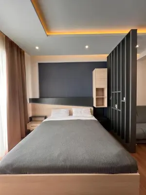 a bedroom with a large bed with a black headboard at PresidentKop LUX Wellness & SPA Apartments in Kopaonik