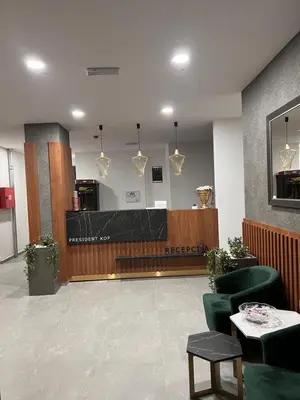 a hotel lobby with a reception desk and chairs at PresidentKop LUX Wellness & SPA Apartments in Kopaonik