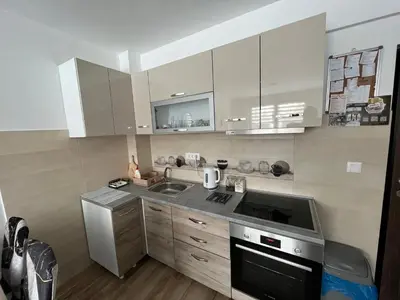 a kitchen with a sink and a stove at Apartments Dora in Kopaonik
