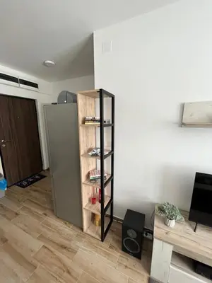 a shelf in a room next to a refrigerator at Apartments Dora in Kopaonik