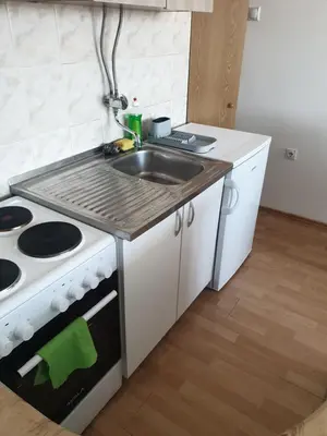 a kitchen with a sink and a stove at City center apartment 2 in Niš