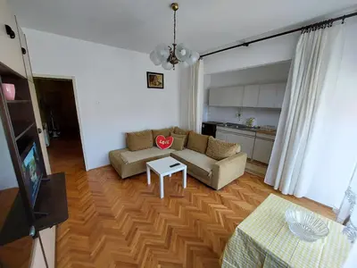 a living room with a couch and a table at Hills Apartment in Niš