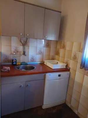 a kitchen with a sink and a counter top at Hills Apartment in Niš