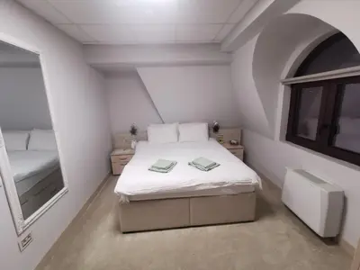 a small bedroom with a bed with two books on it at City SMART in Niš