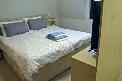 a bedroom with a bed with towels on it at City SMART in Niš